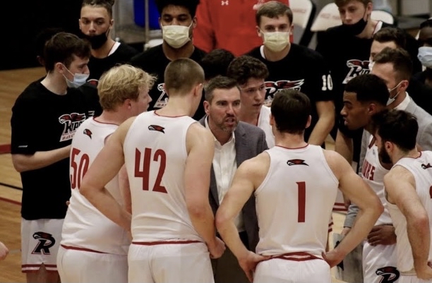 Coach Kane rallies the Red Hawks men's basketball team on the sidelines